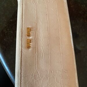 Miu  miu long wallet in cream color used great condition 
Goes for $289
